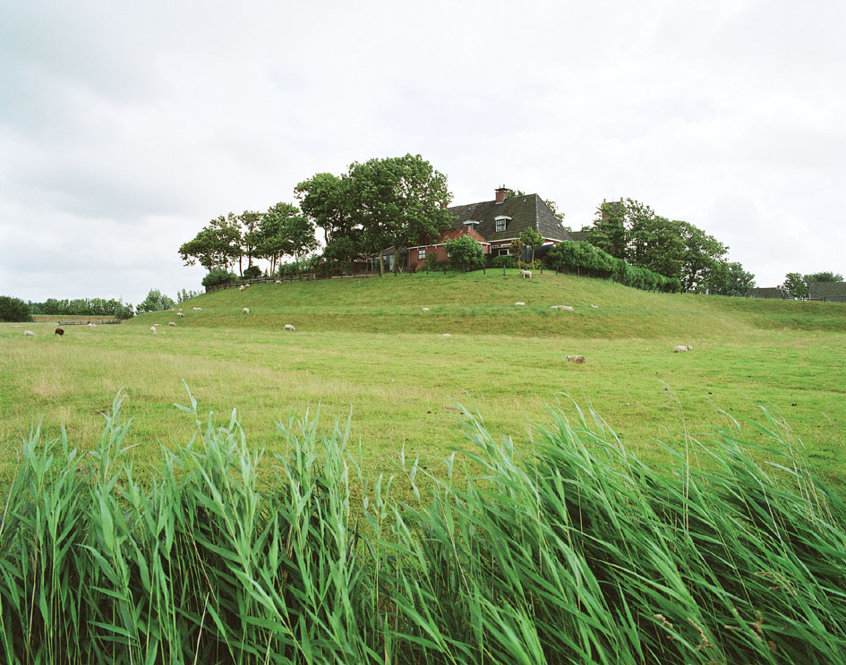 Modern terp in the Netherlands with farmhouse on top